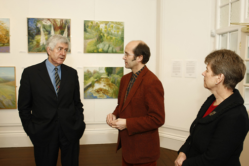 Ceri Thomas showing Rhodri Morgan, AM, and Jane Hutt, AM, the 'Joan Baker: a retrospective' exhibition, 2009